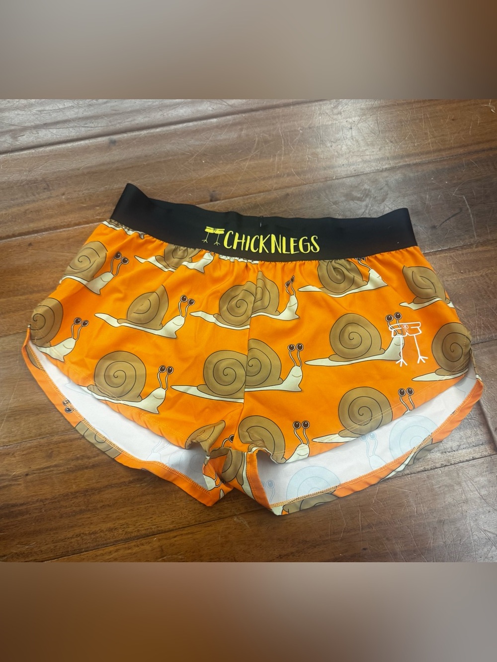 ChicknLegs Women's Orange Snail Print Athletic Shorts